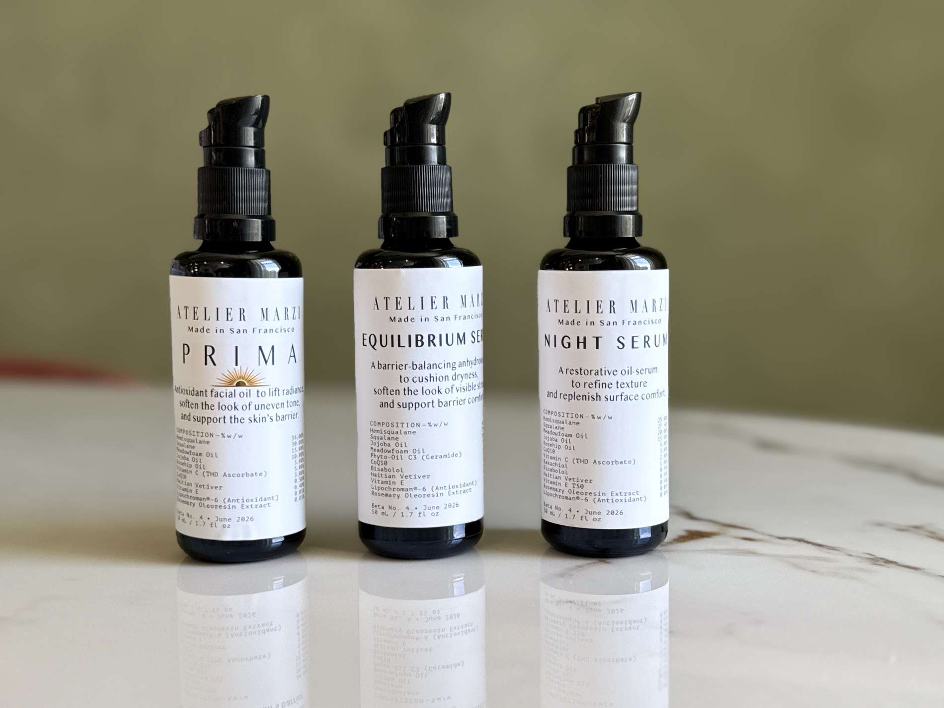 The three Beta 4 bottles standing together on a marble surface